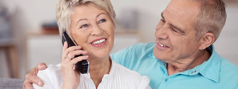 Older couple talking on telephone