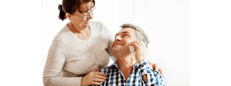 Older couple talking on telephone