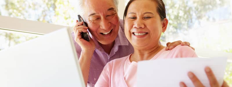 Older couple talking on telephone